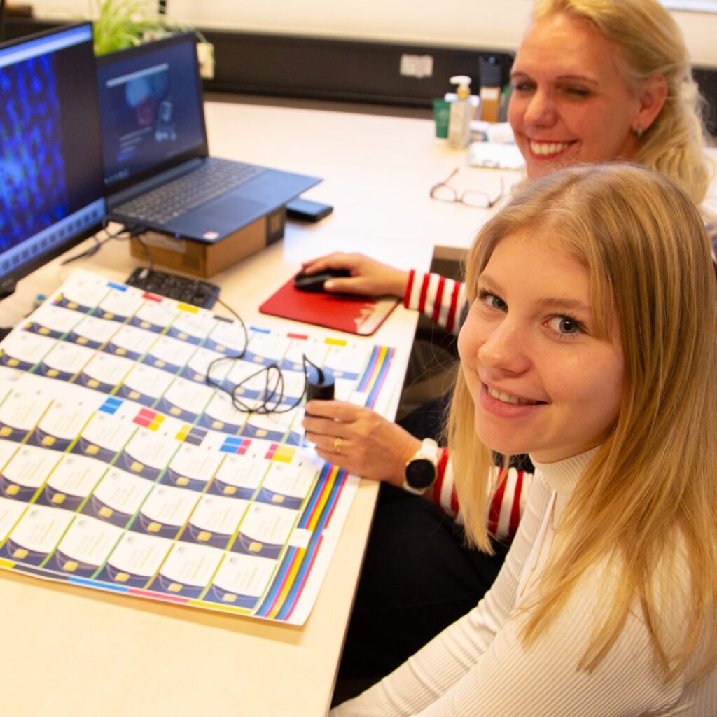 Biopolymer paper IM POYLMER Ute Zimmermann and Lizzy checking printed biopolymer paper with microscope